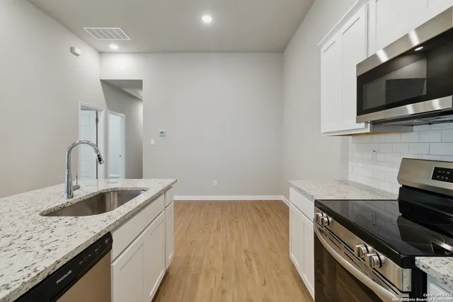 a kitchen with a sink and a microwave