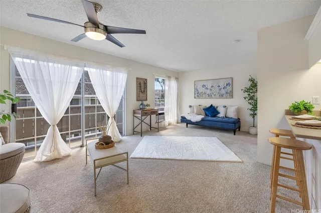 a living room with furniture a flat screen tv and a large window