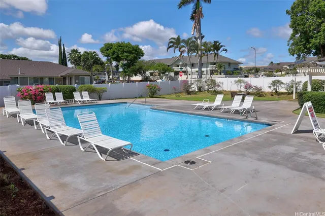 a view of a swimming pool with outdoor seating