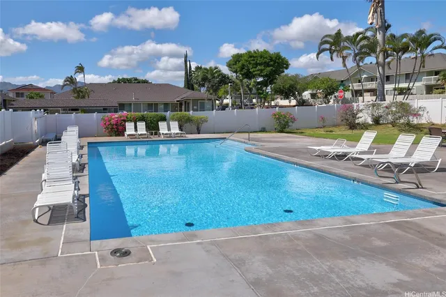 a view of a swimming pool with a lounge chairs