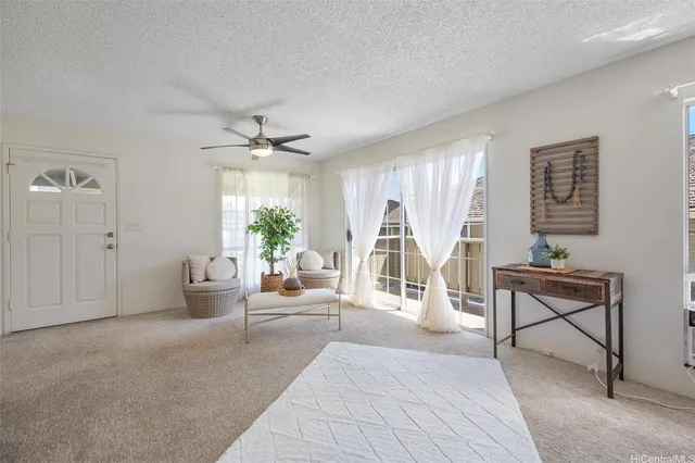 a living room with furniture a table and a potted plant