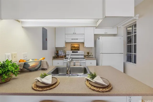 a living room with furniture and a refrigerator