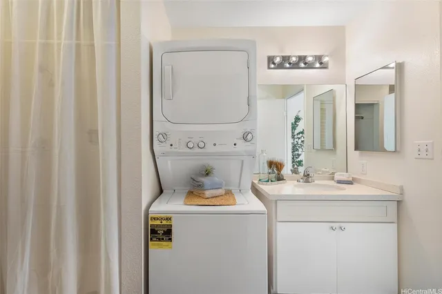 a bathroom with a sink mirror vanity and toilet