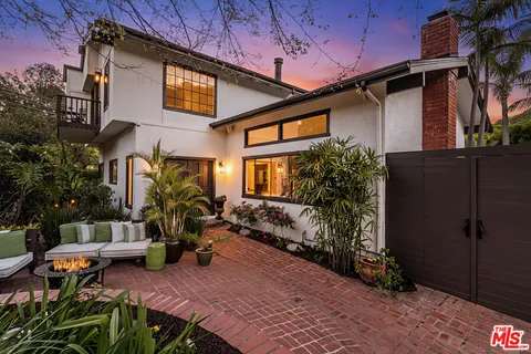 a view of a house with backyard and sitting area