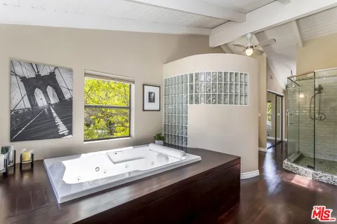 a living room with a bed and a window