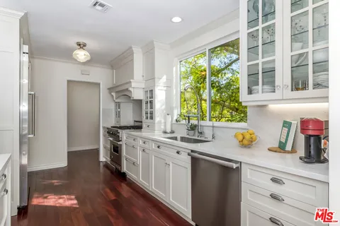 a kitchen with a sink stove and cabinets