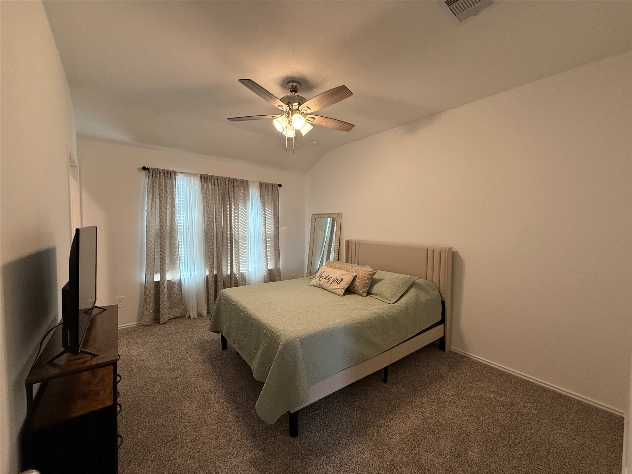 5607 Redstone Gardens Drive Spring, TX 77373 - Photo 6 of 13 a bedroom with a bed and a flat screen tv