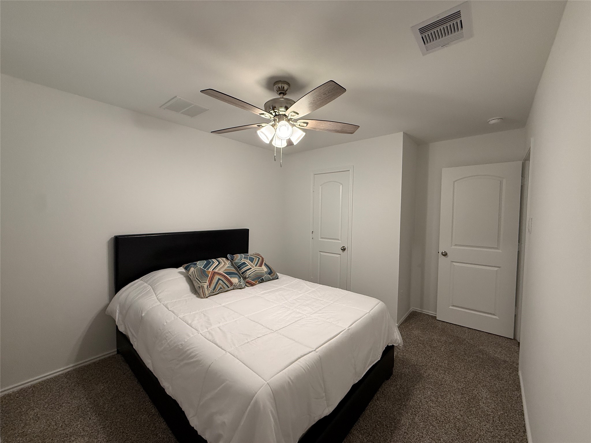 5607 Redstone Gardens Drive Spring, TX 77373 - Photo 7 of 13 a bedroom with a bed and a chandelier