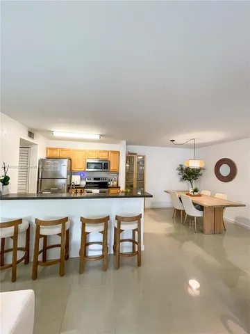 a view of a kitchen with dining table and chairs
