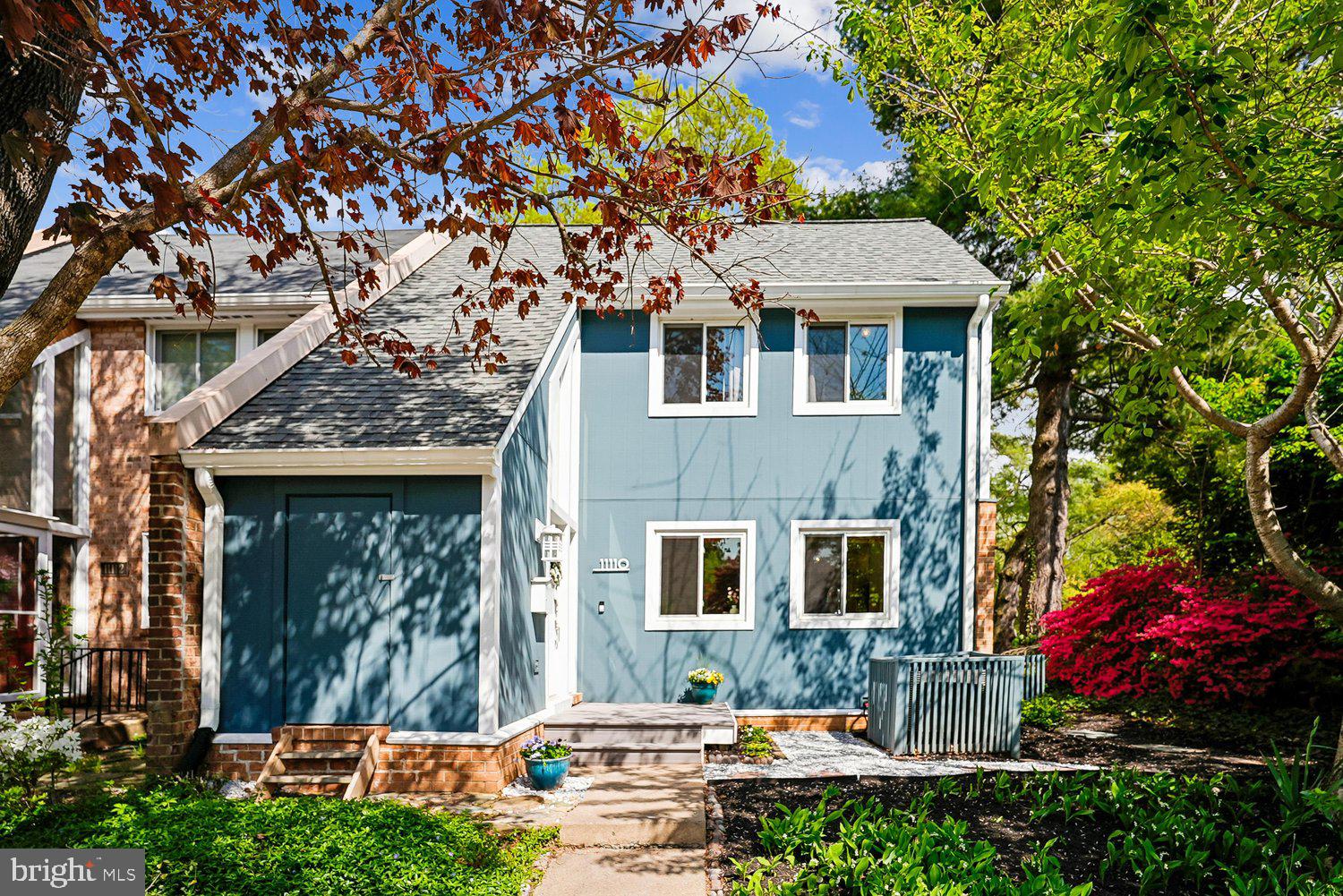 11110 Forest Edge Drive Reston, VA 20190 - Photo 2 of 46 Charming blue home nestled in vibrant greenery.