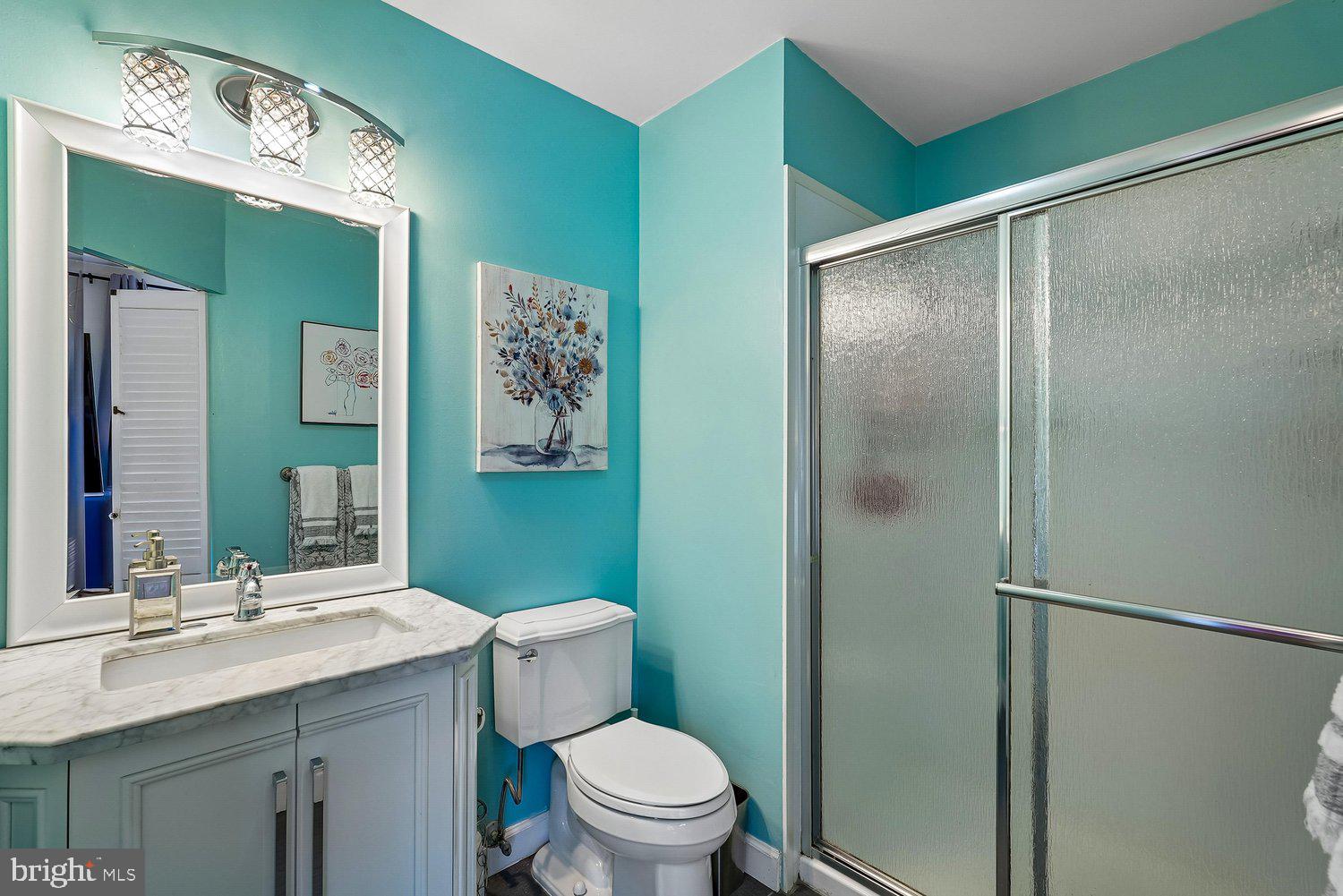 11110 Forest Edge Drive Reston, VA 20190 - Photo 21 of 46 Vibrant turquoise bathroom with modern fixtures.