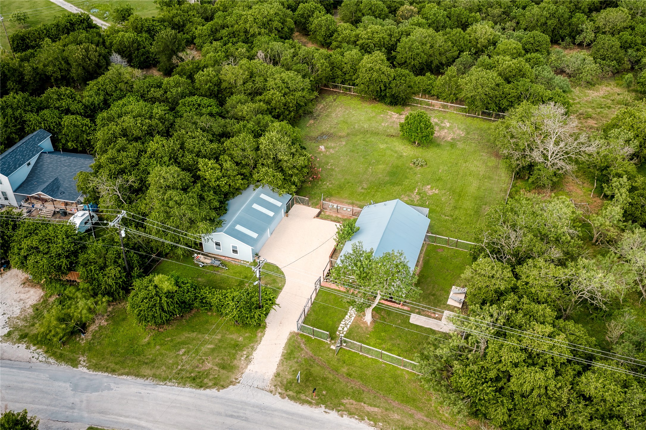372 Old Lockhart Road Lockhart, TX 78644 - Photo 6 of 40 An aerial view captures the property's serene, tree lined landscape.