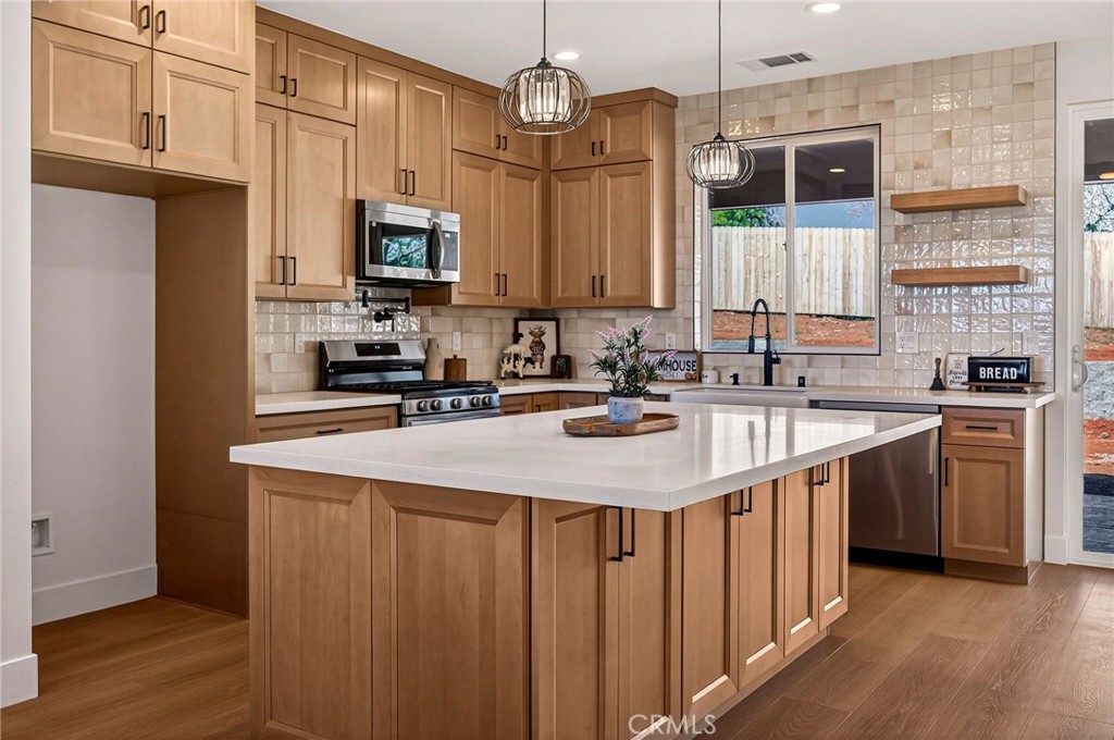 1528 Forest Paradise, CA 95969 - Photo 17 of 49 a kitchen with stainless steel appliances a sink stove and cabinets