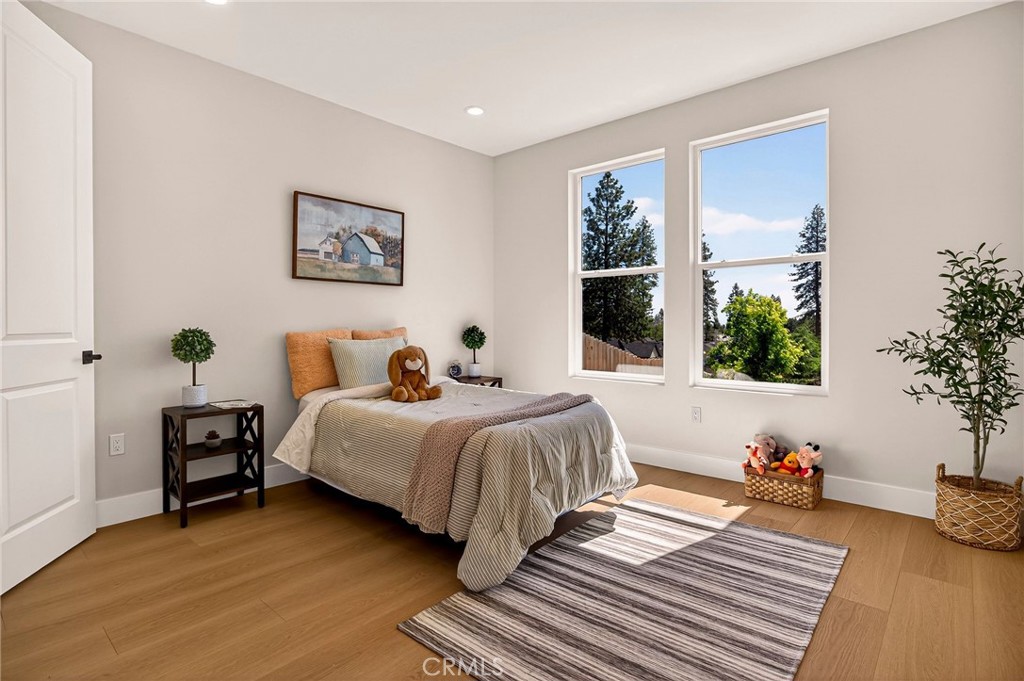 1528 Forest Paradise, CA 95969 - Photo 27 of 49 a spacious bedroom with a bed a dresser and next to a window