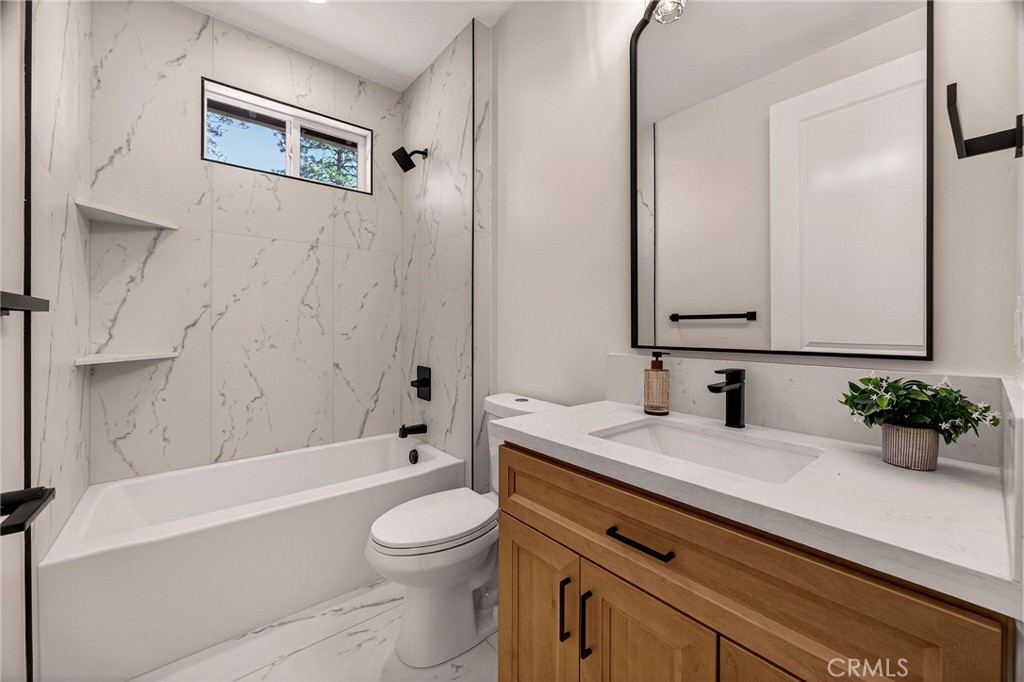1528 Forest Paradise, CA 95969 - Photo 30 of 49 a bathroom with a granite countertop sink a toilet a mirror and bathtub