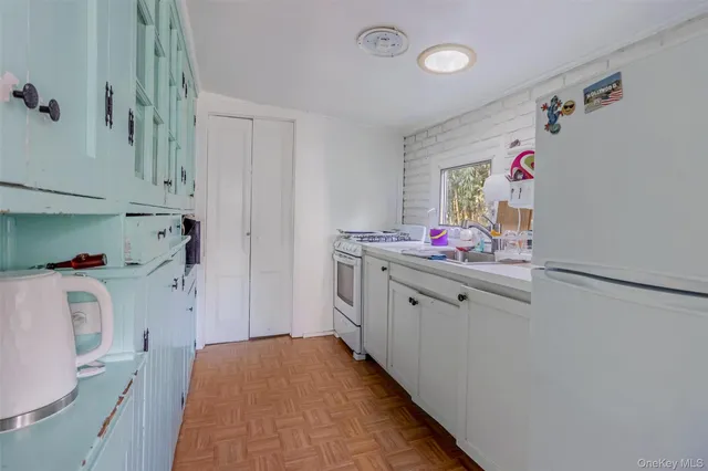 a storage room with wooden floor washer and dryer