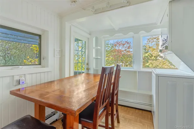 a view of a dining room with furniture and a window