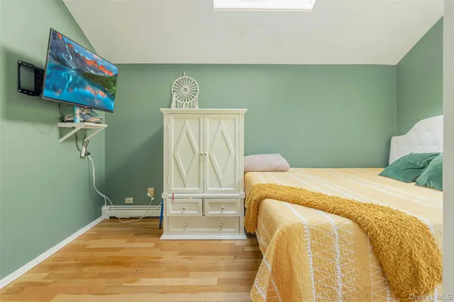 a bedroom with a bed and a painting on the wall