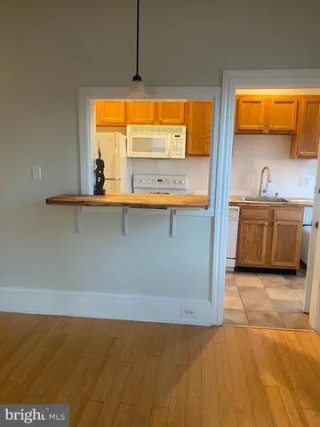 a view of kitchen with stainless steel appliances granite countertop sink and cabinets
