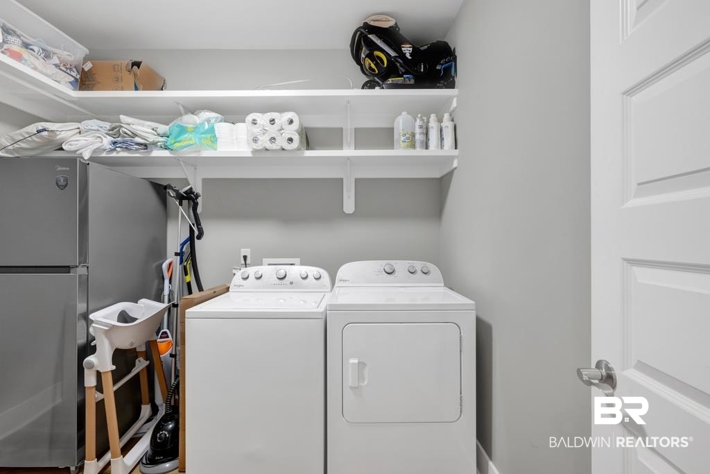 379 Pecan Ridge Boulevard Fairhope, AL 36532 - Photo 20 of 21 Dedicated laundry area featuring a white washing machine and dryer