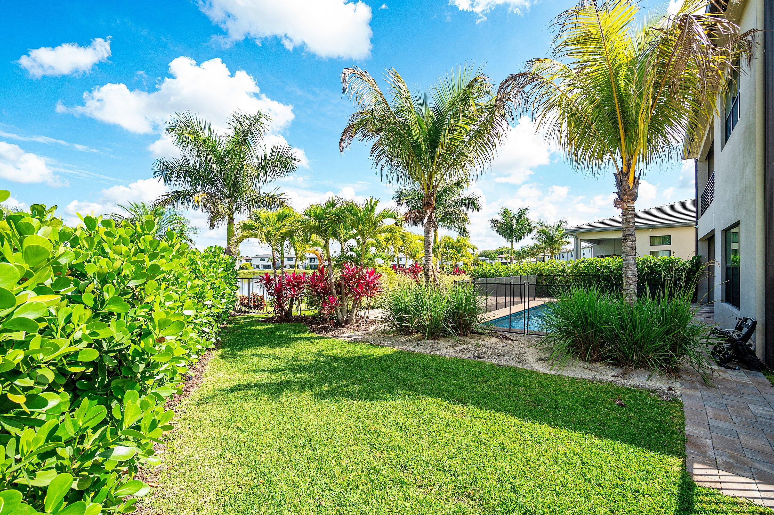8233 Crystal Downs Avenue Boca Raton, FL 33434 - Photo 56 of 58 a view of a yard with a palm tree