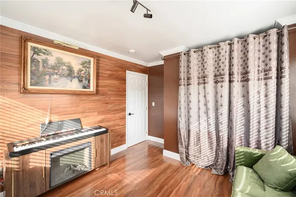 a kitchen with stainless steel appliances granite countertop a stove a sink and a white cabinets with wooden floor