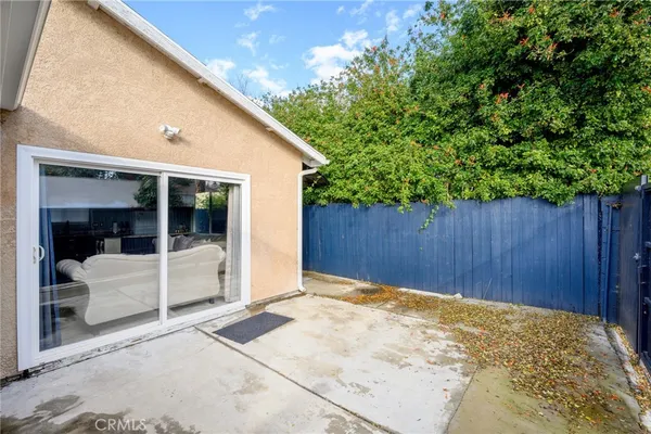 a view of backyard with tub and wooden fence