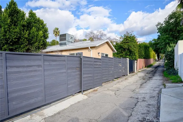 a view of a wooden fence and a potted plant
