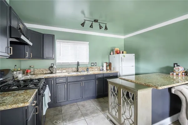 a kitchen that has a sink and a stove in it
