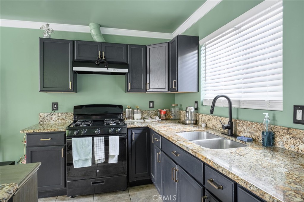 10604 Plainview Avenue Tujunga, CA 91042 - Photo 7 of 14 a kitchen with stainless steel appliances granite countertop a sink stove and cabinets