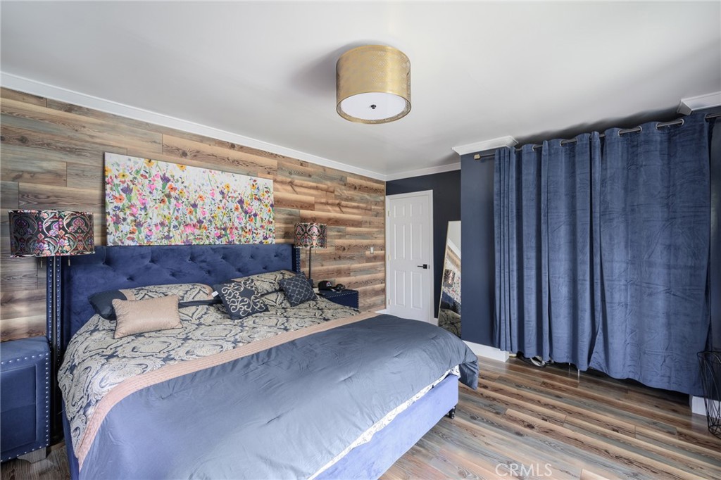 10604 Plainview Avenue Tujunga, CA 91042 - Photo 9 of 14 a bedroom with a bed and a painting on the wall