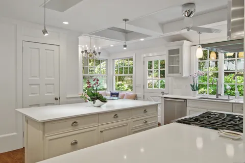 a kitchen with a sink and large window