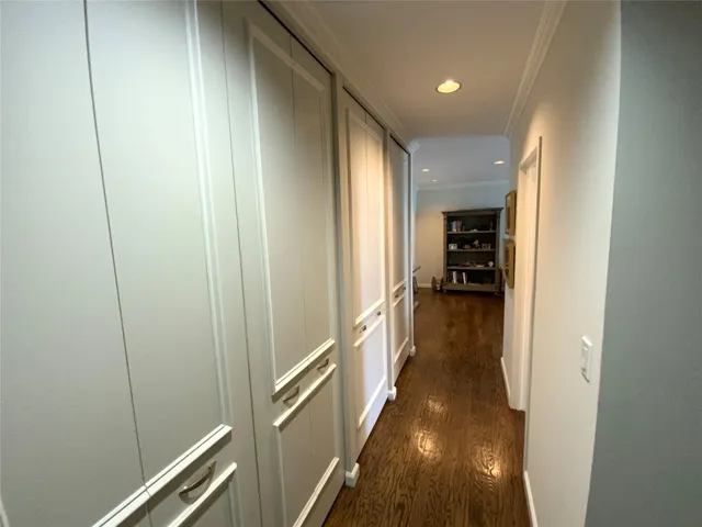 a view of hallway with wooden floor
