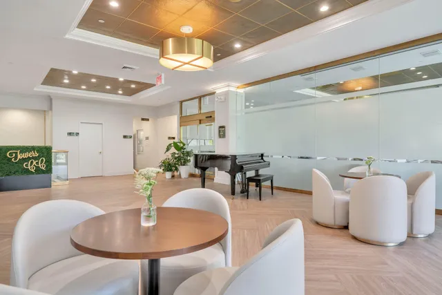 a dining room with furniture and a chandelier