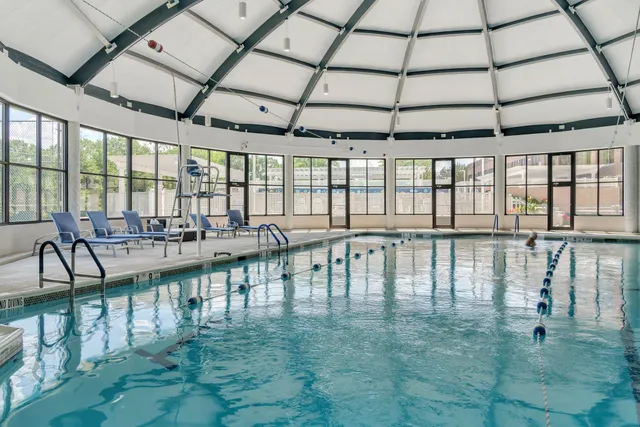 a view of a swimming pool with outdoor seating