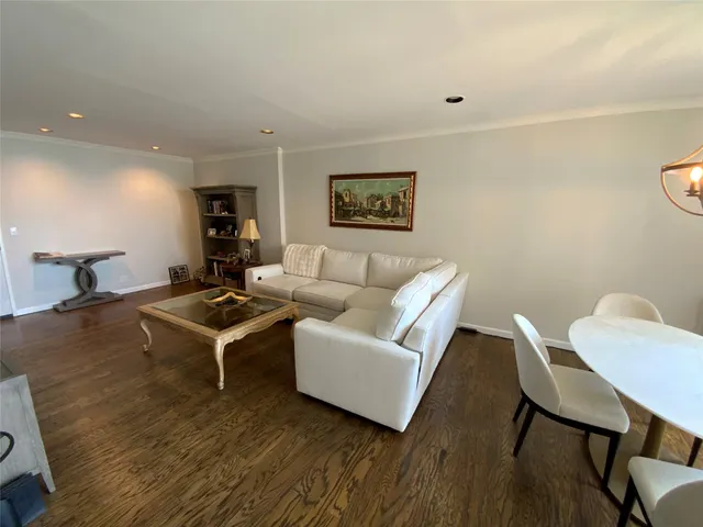 a living room with furniture a rug and a painting on the wall