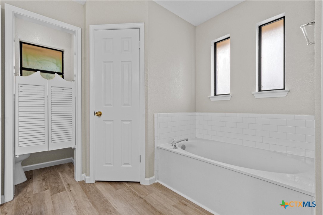 180 County Road 4933 Kempner, TX 76539 - Photo 17 of 24 a white bath tub sitting next to a window
