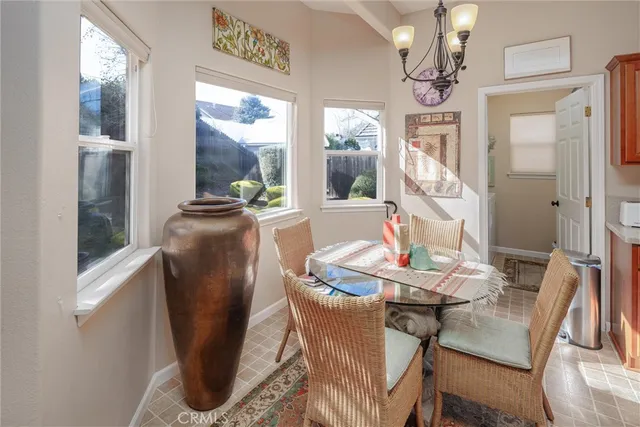 a dining room with furniture a chandelier and wooden floor