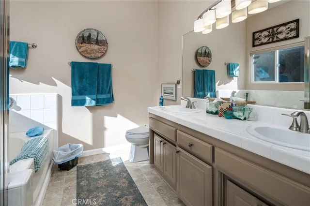 a bathroom with double vanity sink and a mirror