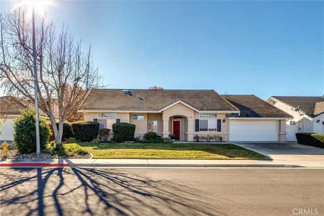 a view of a house with a big yard and large trees