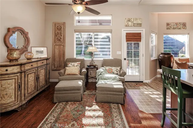 a living room with furniture a fireplace and large windows