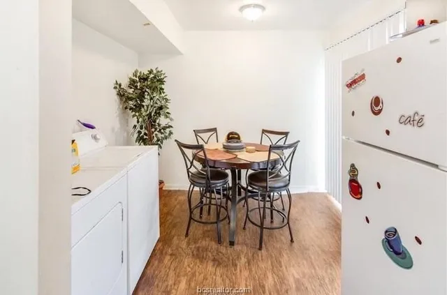 a dining room with furniture and wooden floor