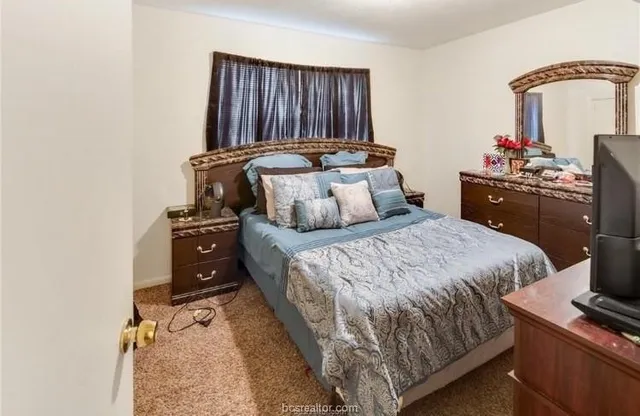 a bedroom with a bed and a dresser