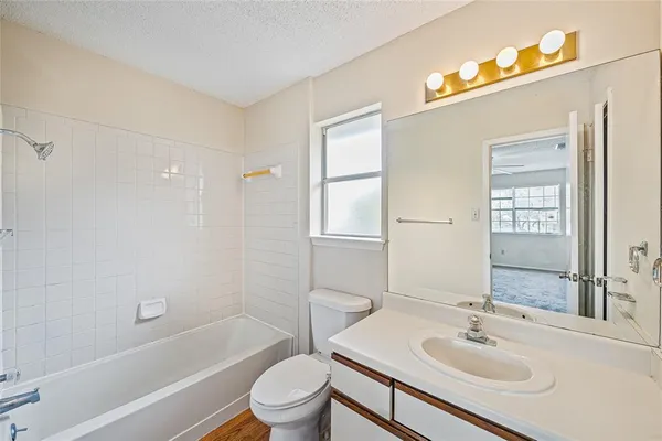 a bathroom with a sink toilet tub and shower