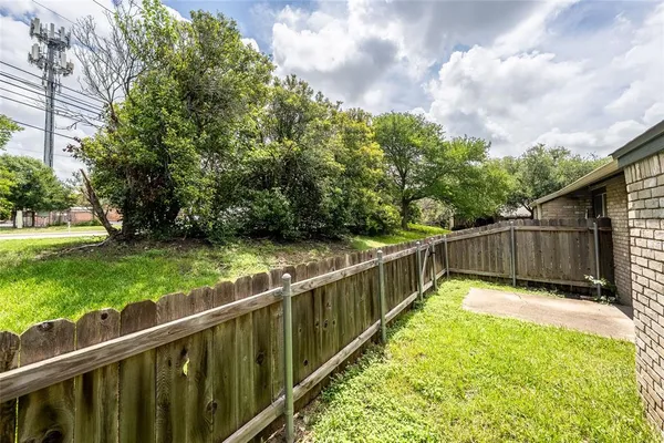 a view of a garden with wooden deck