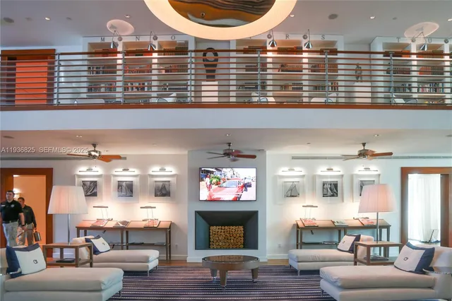 a living room with fireplace furniture and a large window