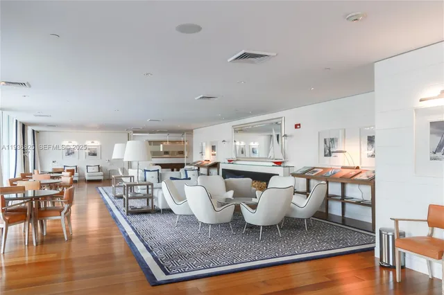 a large white kitchen with a table and chairs