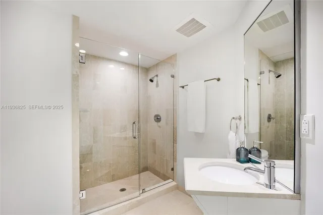 a bathroom with a shower a mirror and a shower