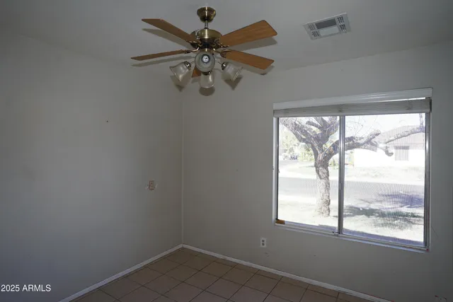 a view of a hallway with a chandelier fan