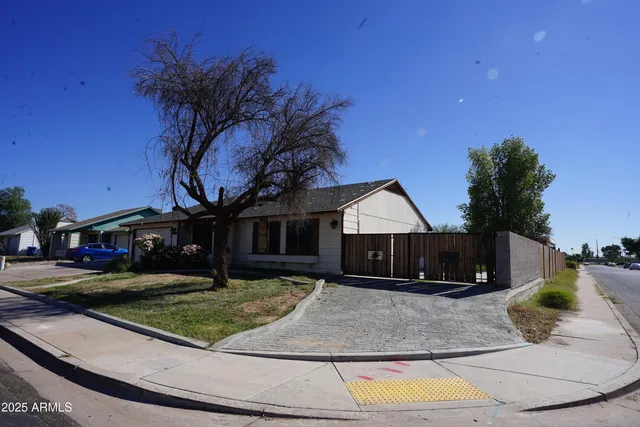 a front view of a house with a yard and trees